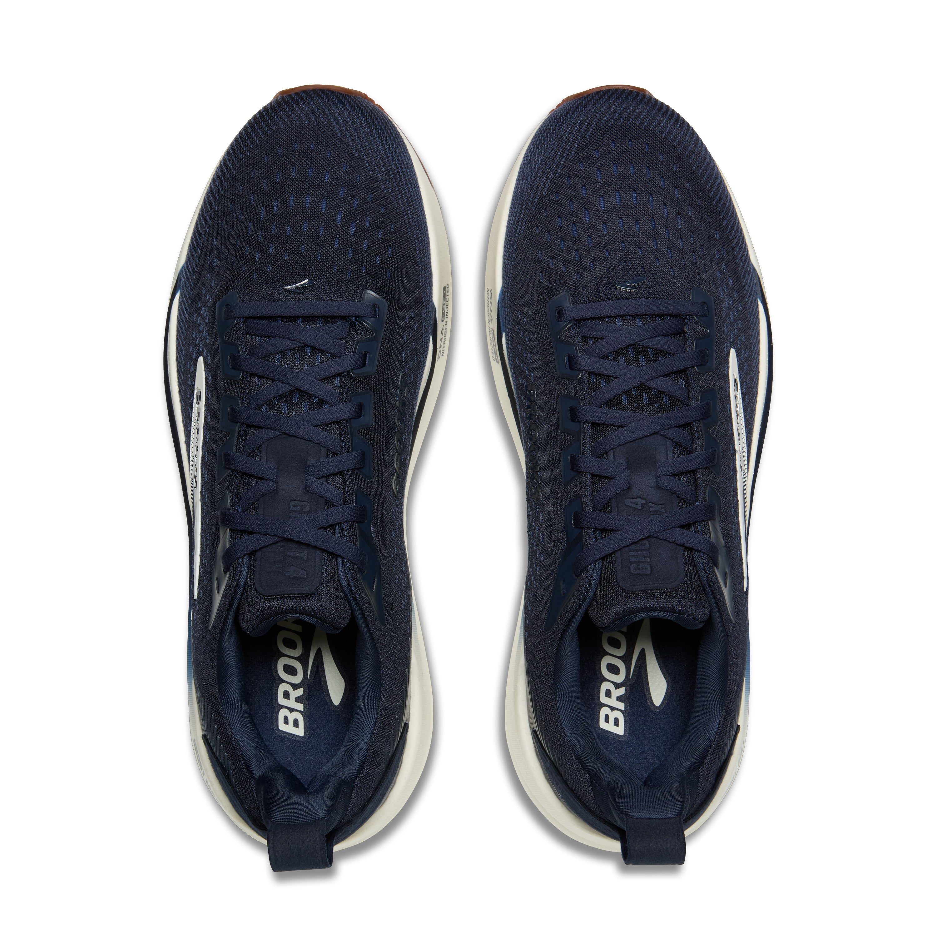 Navy running shoes with white soles on a white background