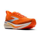 Orange running shoe with white sole on a white background