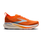 Orange running shoe with white sole on a white background
