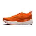 Orange running shoe with white sole on a white background