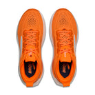Pair of orange running shoes with 'Brooks' branding on a white background