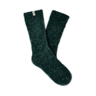 A pair of dark forest green fuzzy socks with a small white brand tag on the cuff, displayed against a solid white background.