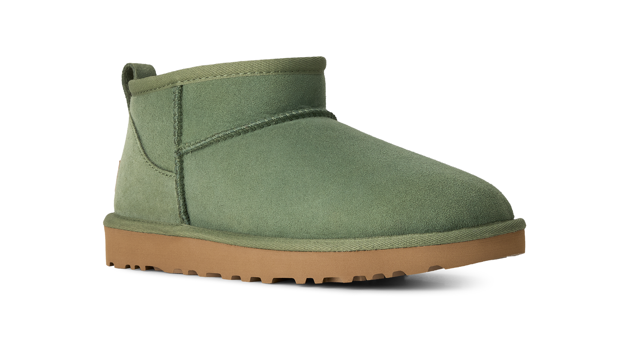 An olive green suede ankle boot with a tan rubber sole, shown from a side profile on a white background.