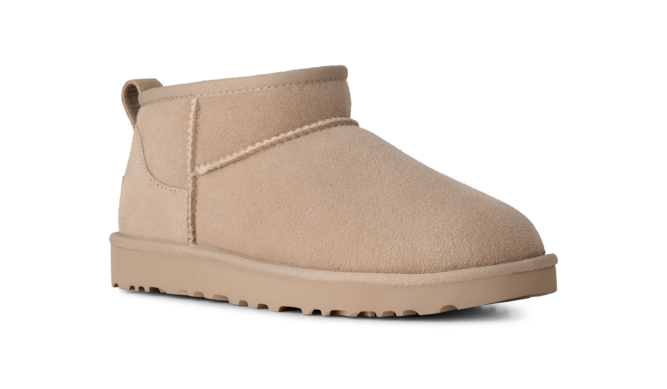A single beige suede ankle boot with a thick matching sole, shown from a side profile on a white background.