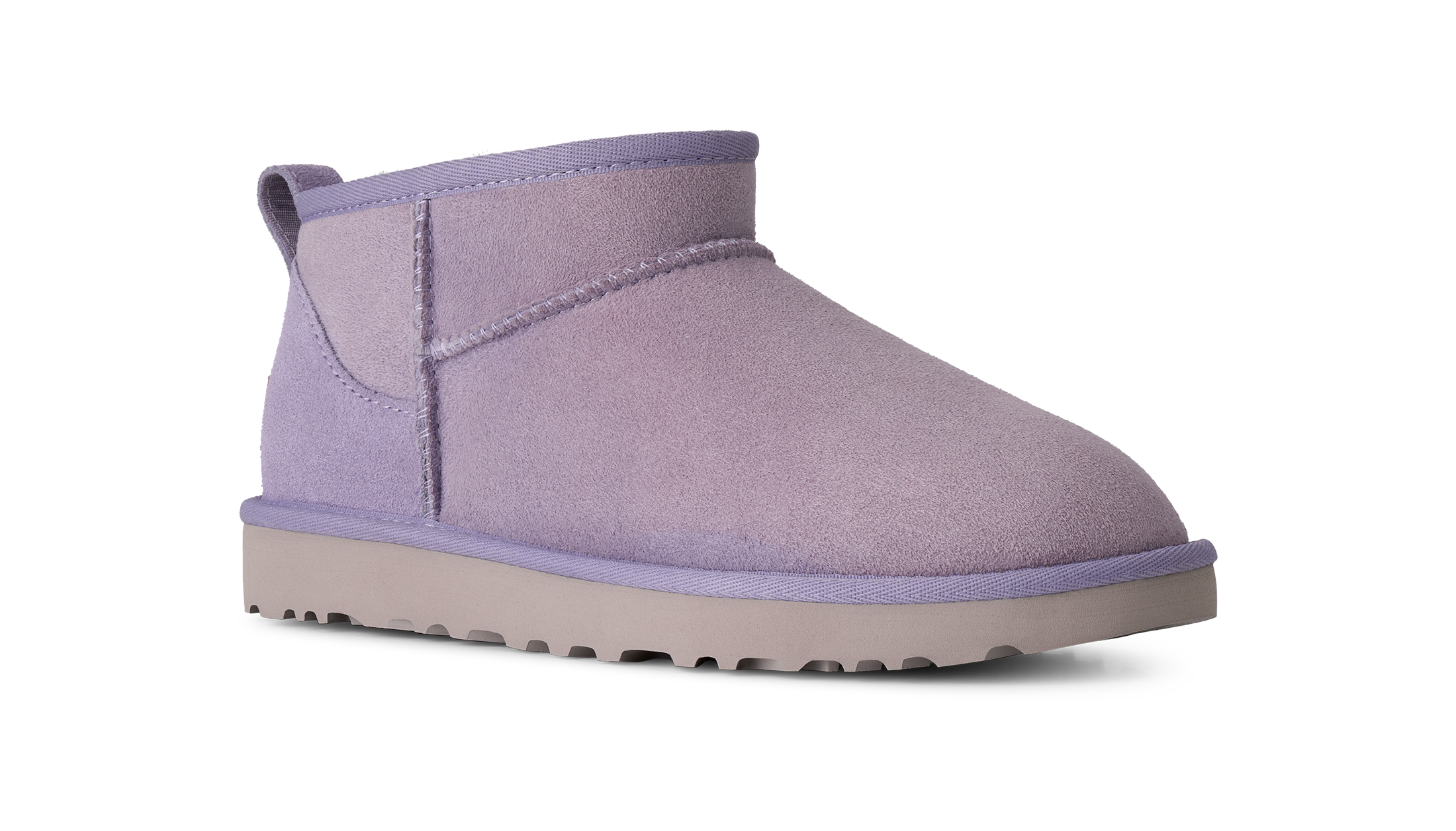 A single mid-calf ankle boot in a dusty lavender purple suede-like material, featuring a thick light gray sole, shown from a side profile on a white background.