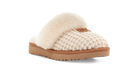 A single slip-on slouchy slipper with a cream knit upper, fluffy cream shearling trim, and a tan sole, shown on a white background.