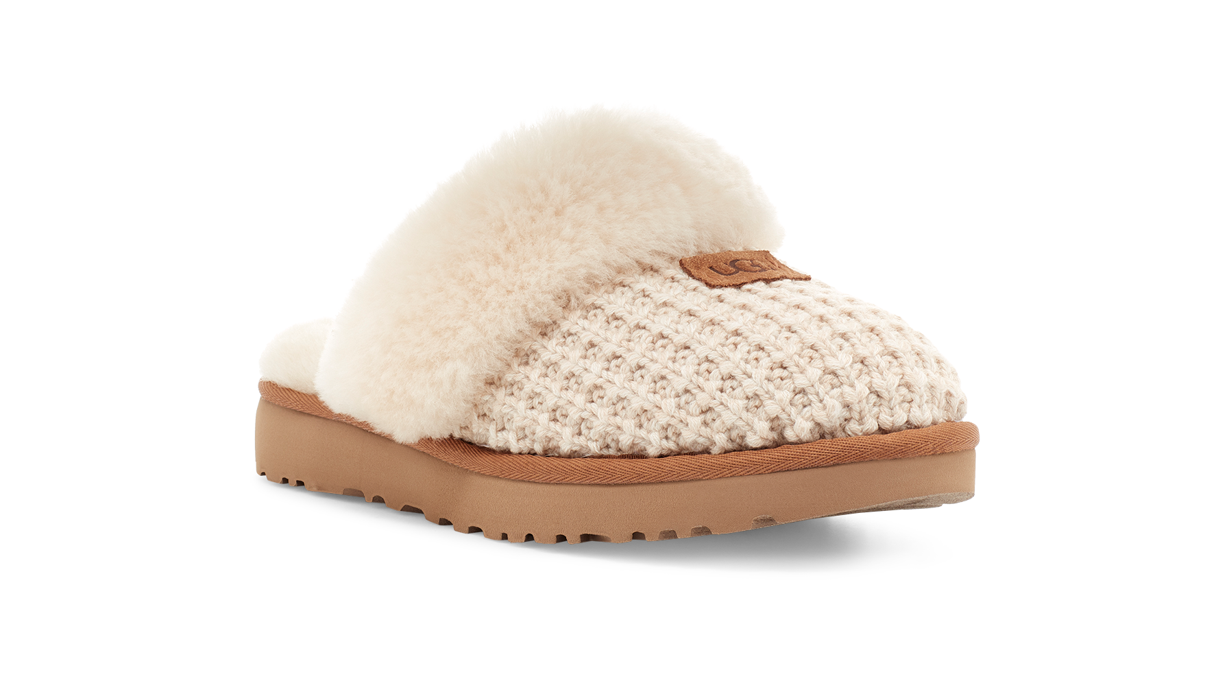 A single slip-on slouchy slipper with a cream knit upper, fluffy cream shearling trim, and a tan sole, shown on a white background.