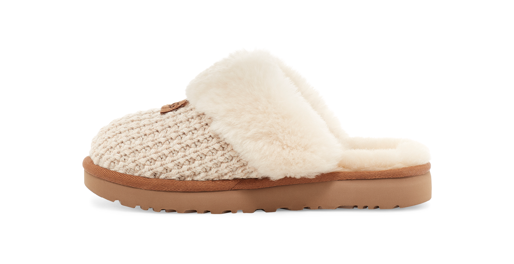 A single slip-on slouchy slipper with a beige knit upper, cream faux fur trim, and a brown sole, shown from the side on a white background.