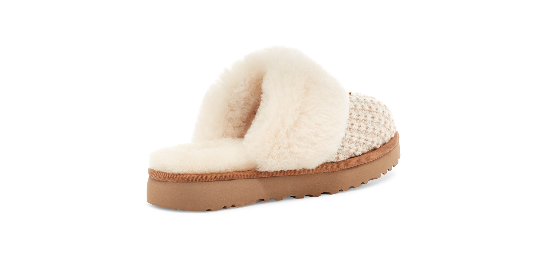 A single slip-on mule slipper shown from the side on a plain white background. The shoe features a fluffy cream faux-fur upper, a beige woven textile side panel, and a tan platform sole.