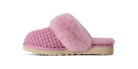A pink knit slip-on mule slipper with a fluffy faux-fur trim and a beige sole, shown in profile against a white background.
