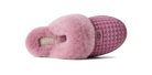A single UGG slipper shown from the side on a white background, featuring a pink fuzzy shearling collar, a textured knit upper in a dusty mauve-pink, and a beige UGG logo patch on the heel.