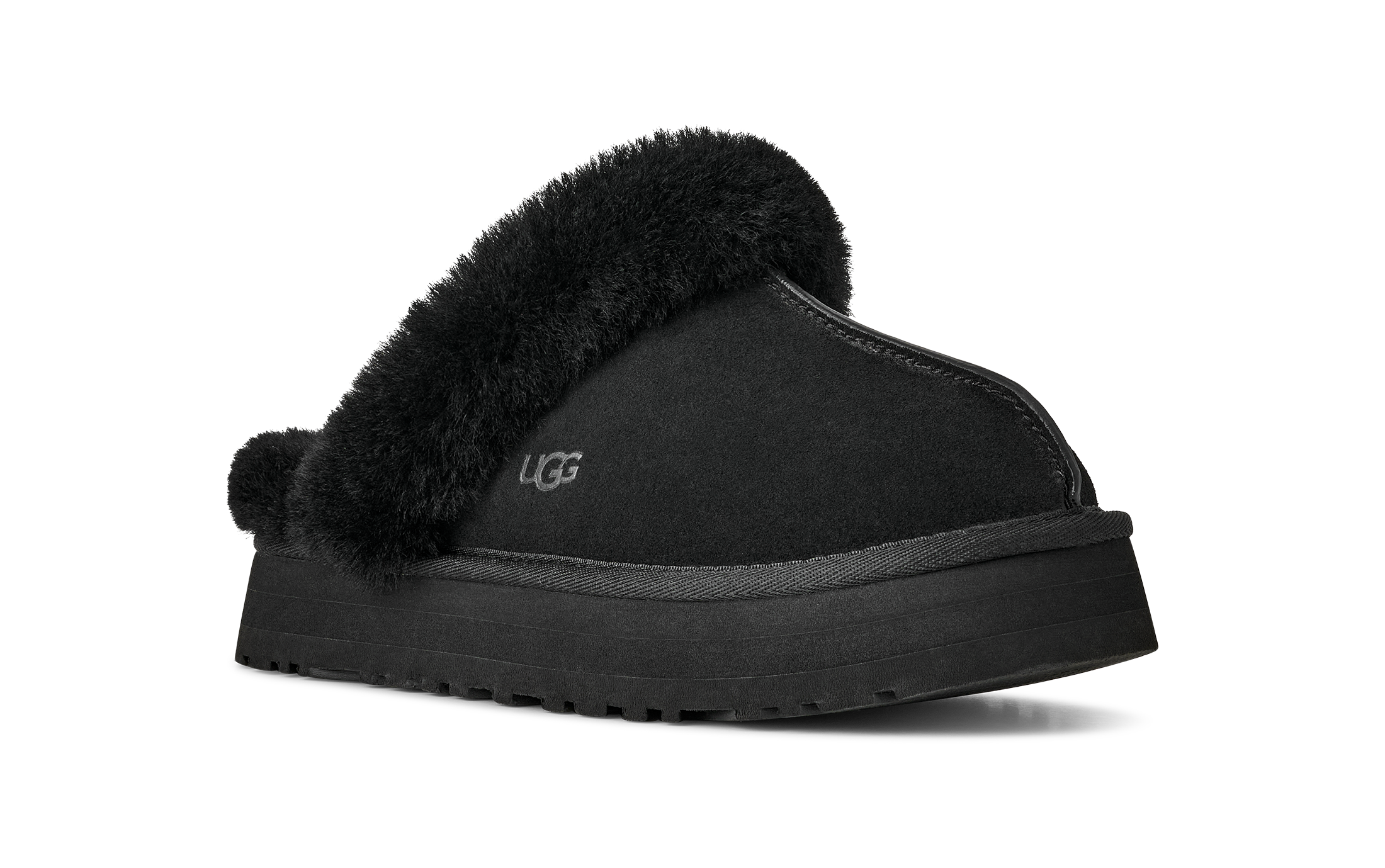 A single black UGG slipper with a thick black platform sole and fluffy black faux-fur trim, shown from a side angle on a white background.