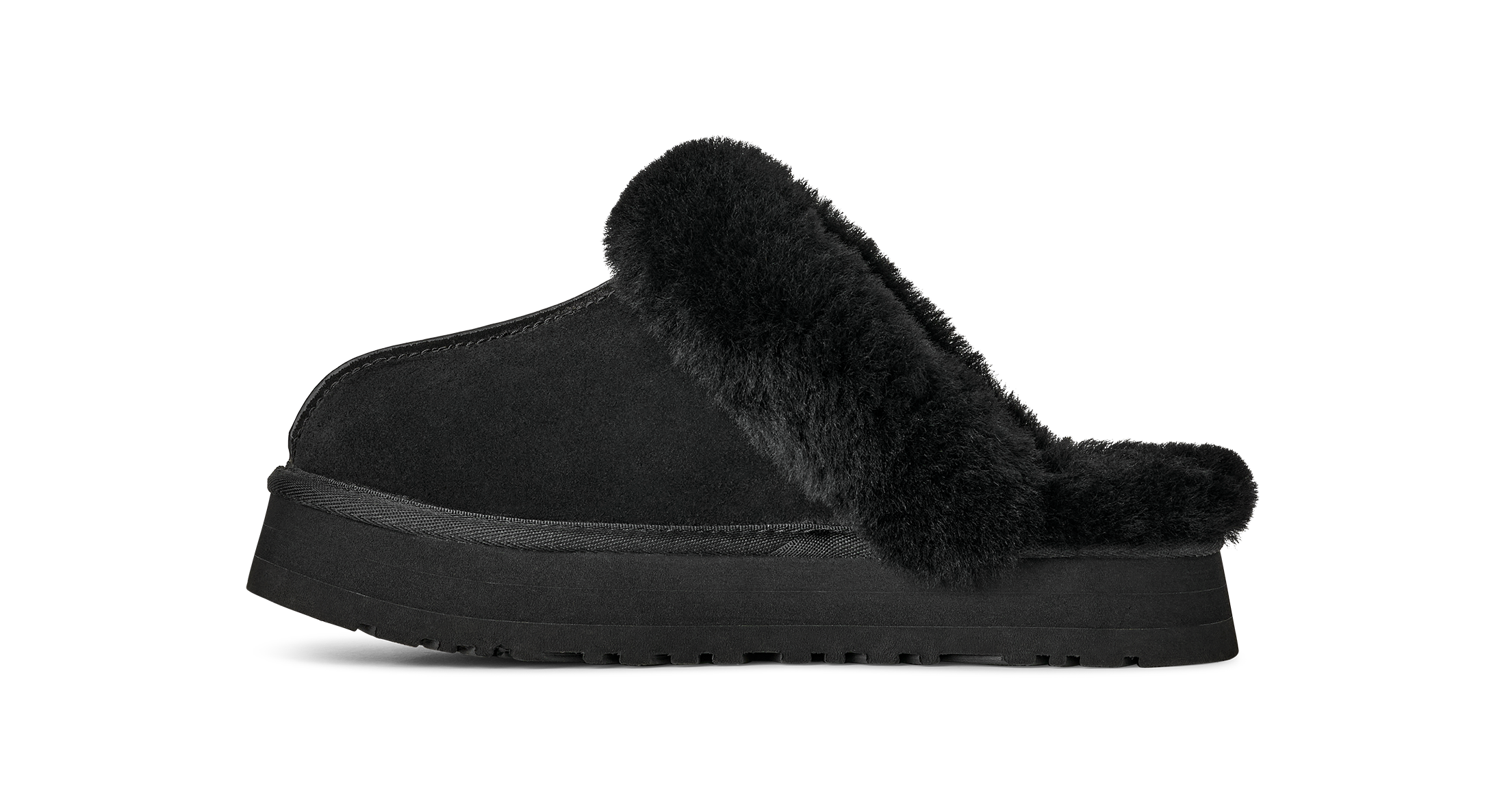 A single black slip-on clog-style slipper with a thick platform sole and fluffy faux-fur trim, shown in side profile on a plain white background.