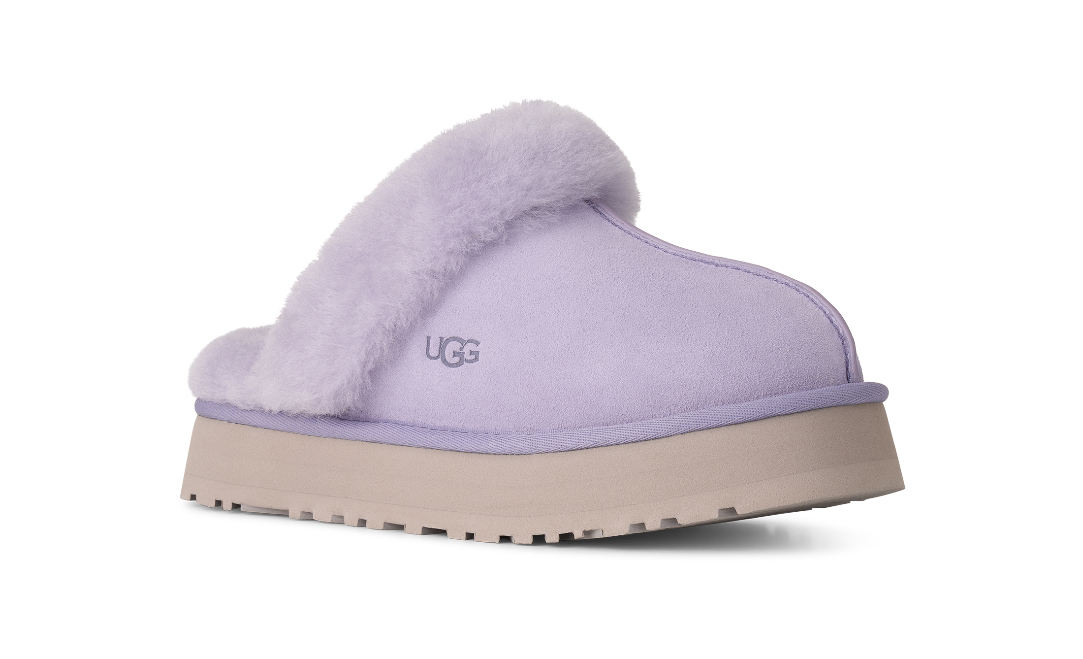 A single UGG slip-on mule slipper in light lavender suede with a fluffy lavender faux-fur collar and a beige platform sole, shown from a side profile on a white background.