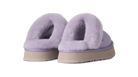 A pair of UGG platform slip-on slippers in light purple lavender, featuring soft fuzzy shearling lining and beige soles, shown against a plain white background.