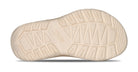Close-up of a beige shoe sole with brand logo on a white background