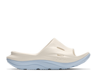 White sandal with light blue sole on a white background