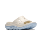 White sandal with blue sole on a white background