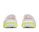 Pair of white athletic shoes with neon green sole on a white background