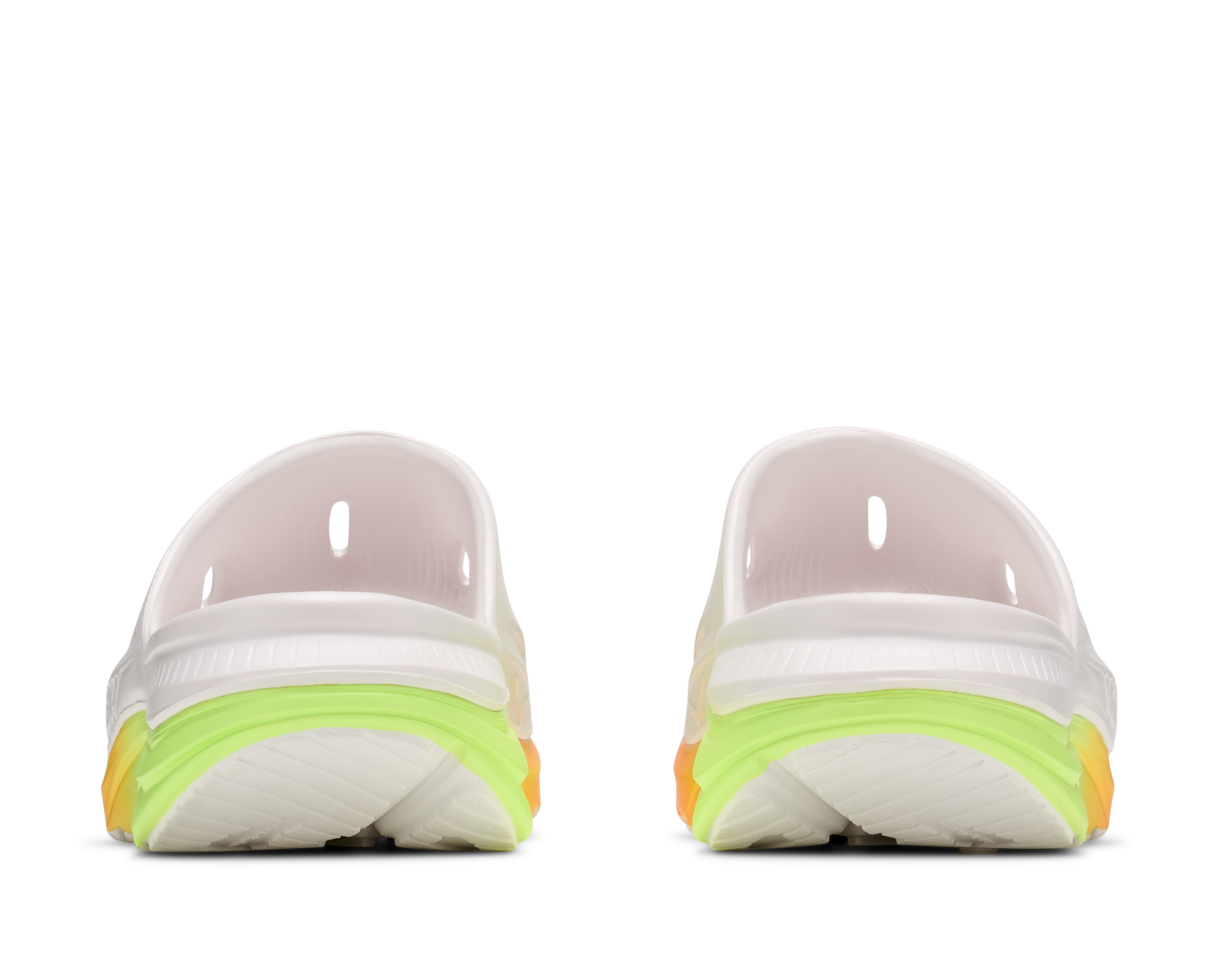 Pair of white athletic shoes with neon green sole on a white background