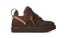 A dark brown UGG lace-up sneaker with a textured mesh upper, suede overlays, a tan leather heel accent, and a thick dark brown sole, shown against a plain white background.
