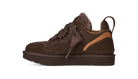A single brown low-top sneaker with a fuzzy brown collar, brown laces, and a tan side accent, shown from the side against a plain white background.
