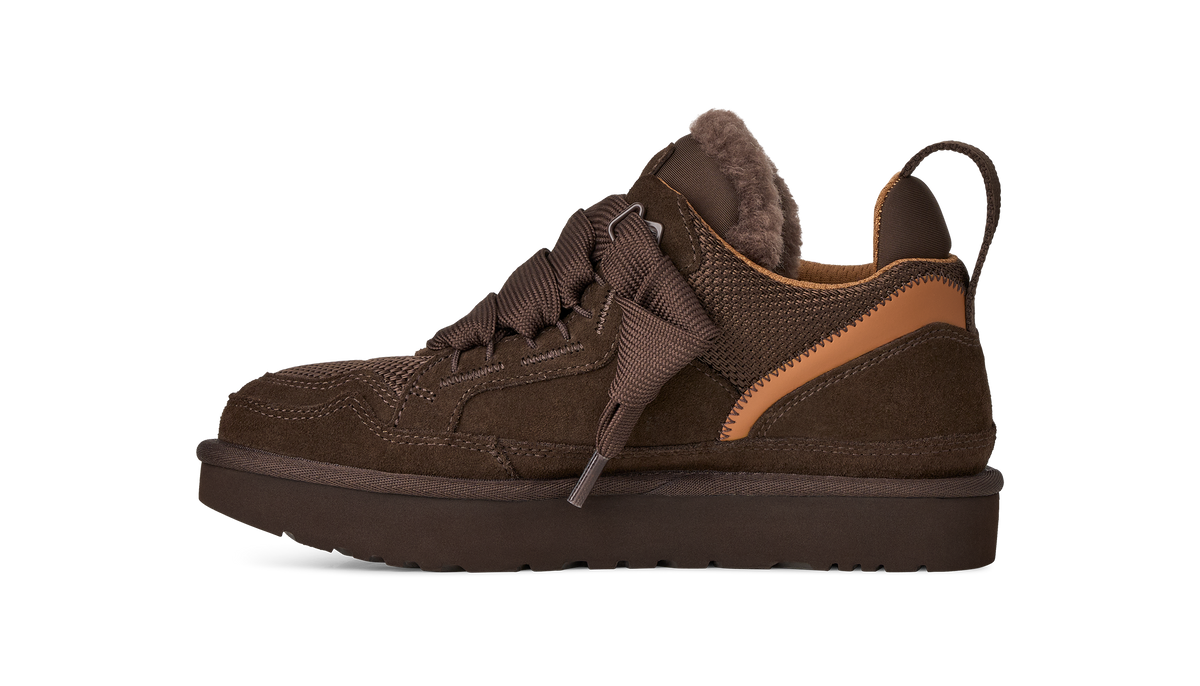 A single brown low-top sneaker with a fuzzy brown collar, brown laces, and a tan side accent, shown from the side against a plain white background.