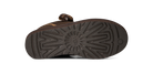 A close-up view of the textured brown outsole of a shoe, showing a circular center tread pattern and a small circular logo on the heel, set against a plain white background.