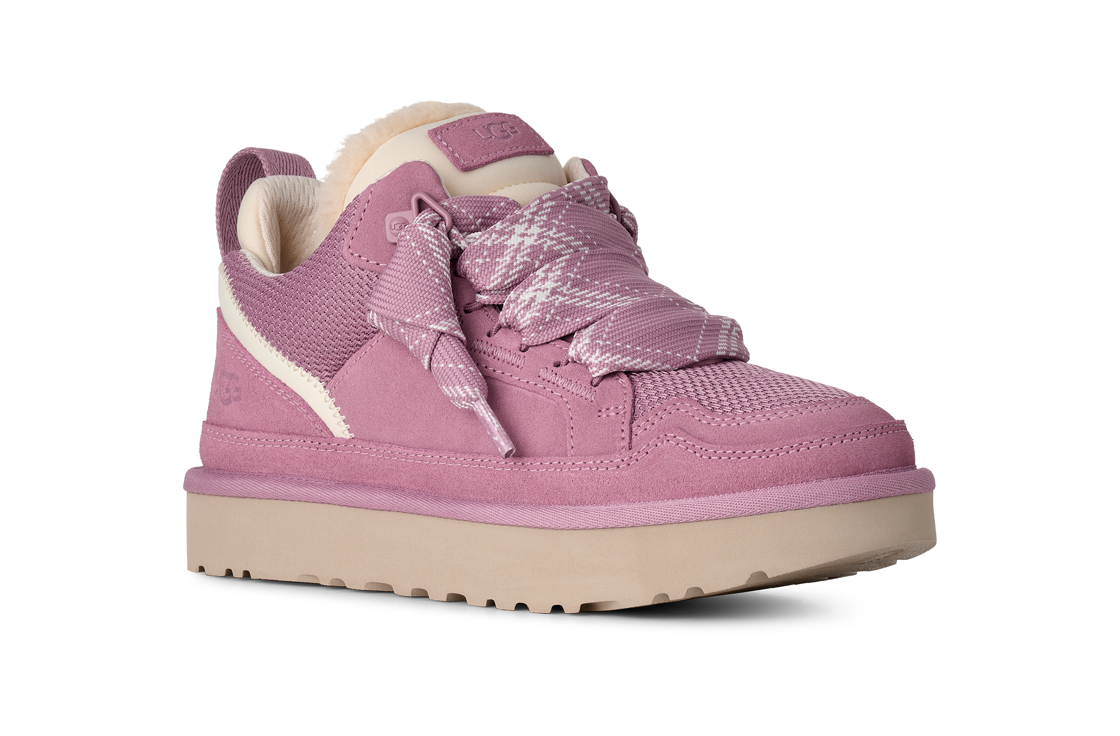 A pink low-top sneaker with a textured knit upper, matching pink laces, a light beige sole, and a soft cream-colored lining, shown against a plain white background.