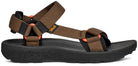 Brown sandal with black sole on a white background
