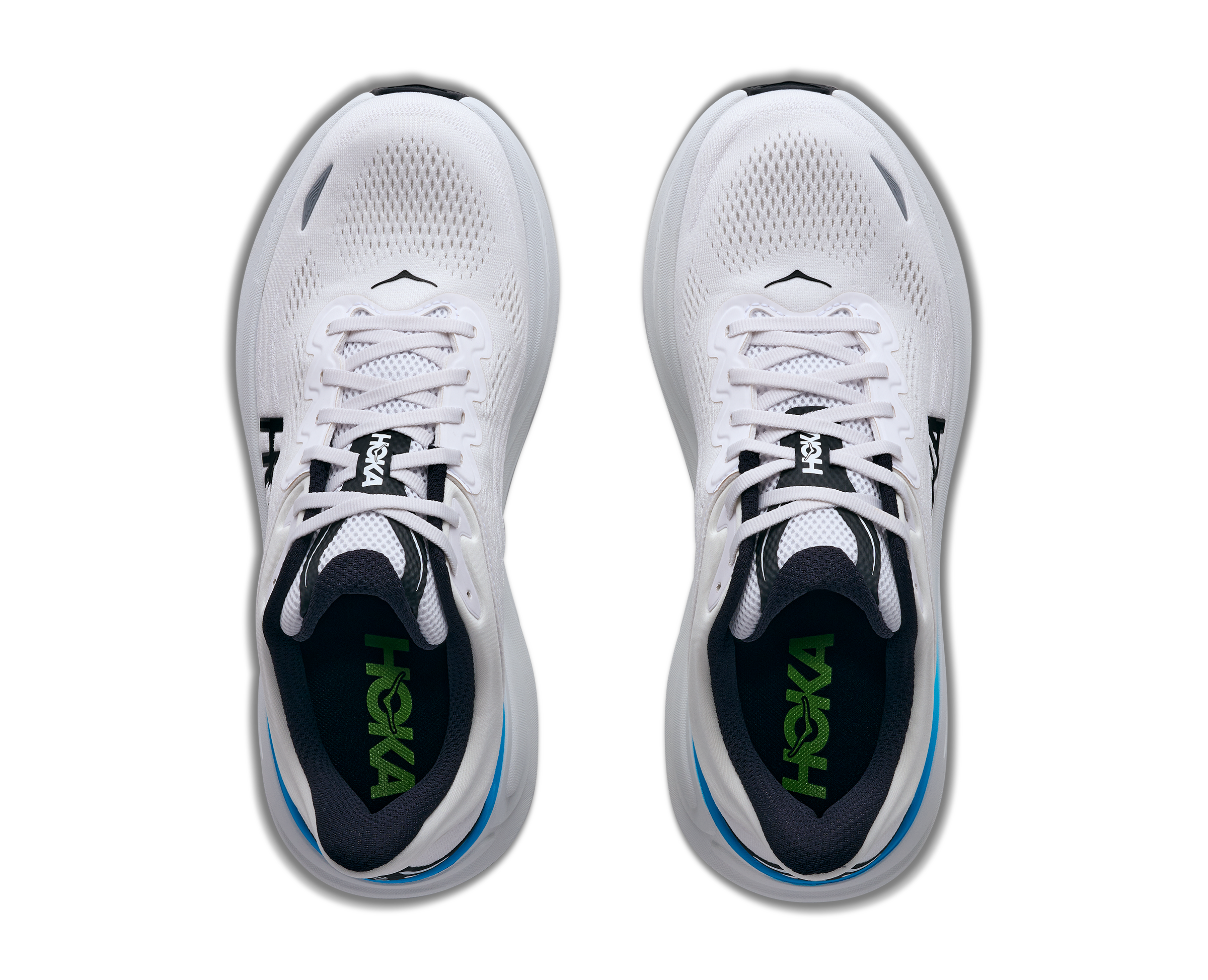 White running shoes with black and green accents on a white background