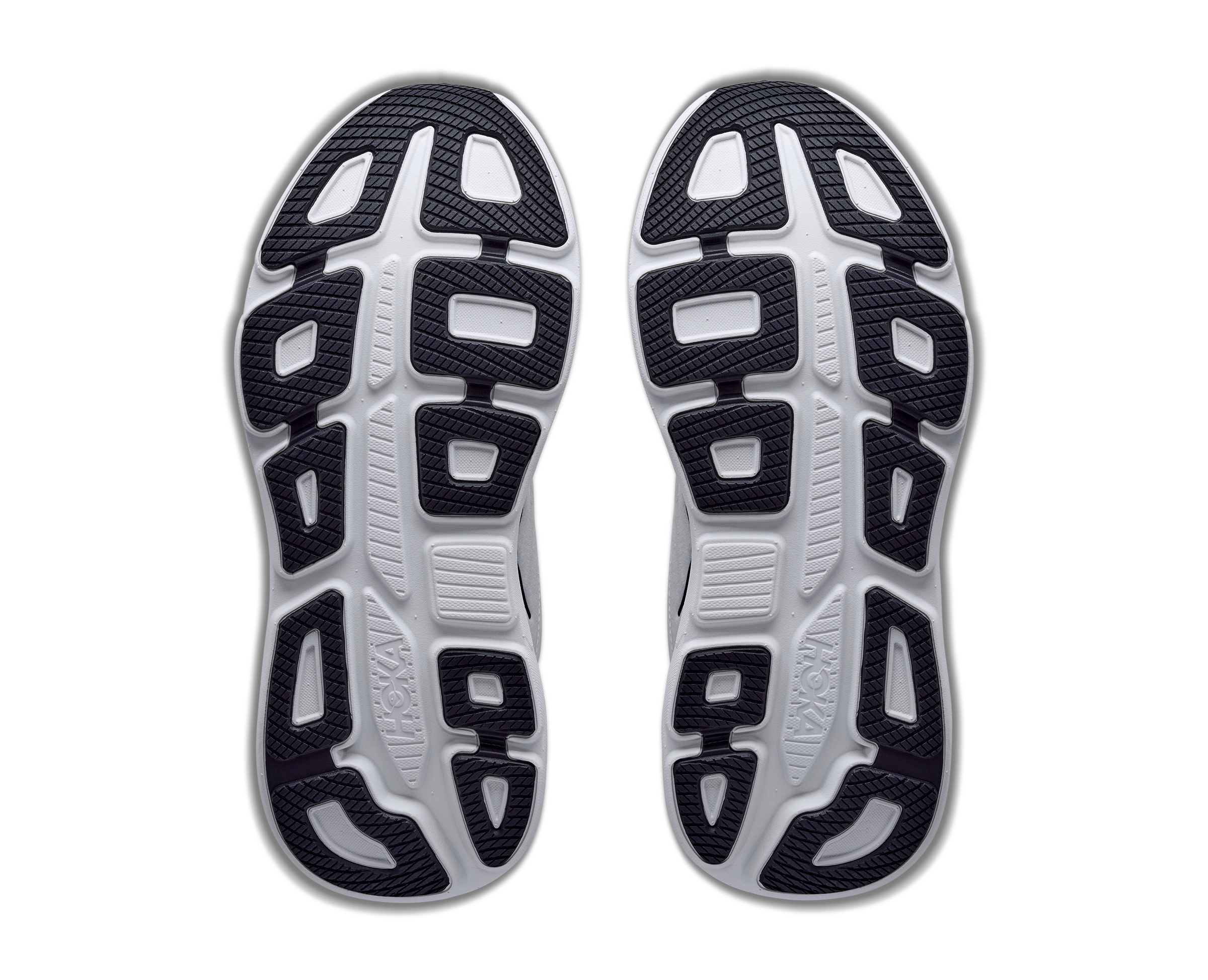Close-up of a pair of running shoes with a focus on the sole design.