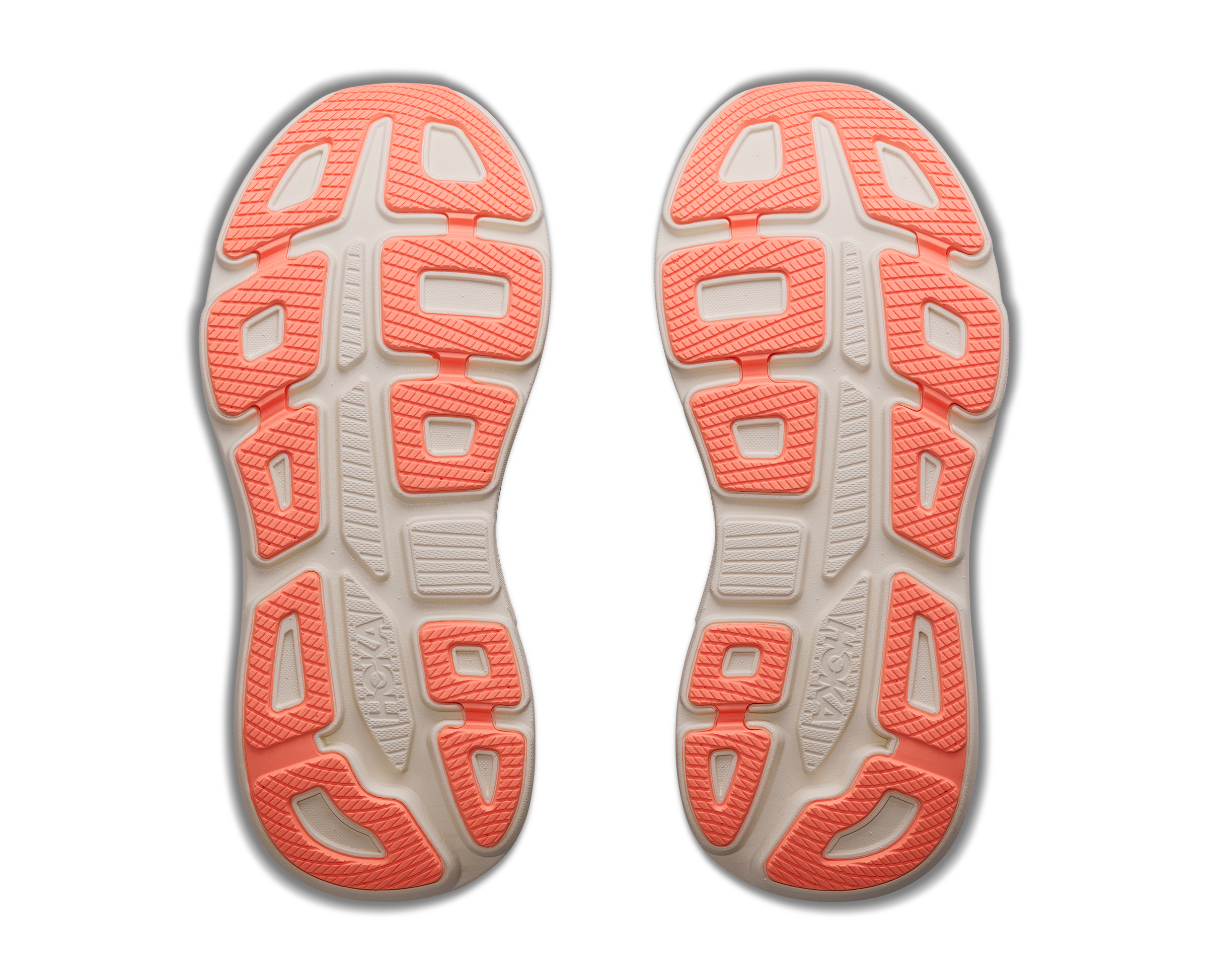 Close-up of a pair of running shoes with orange sole pattern on a white background