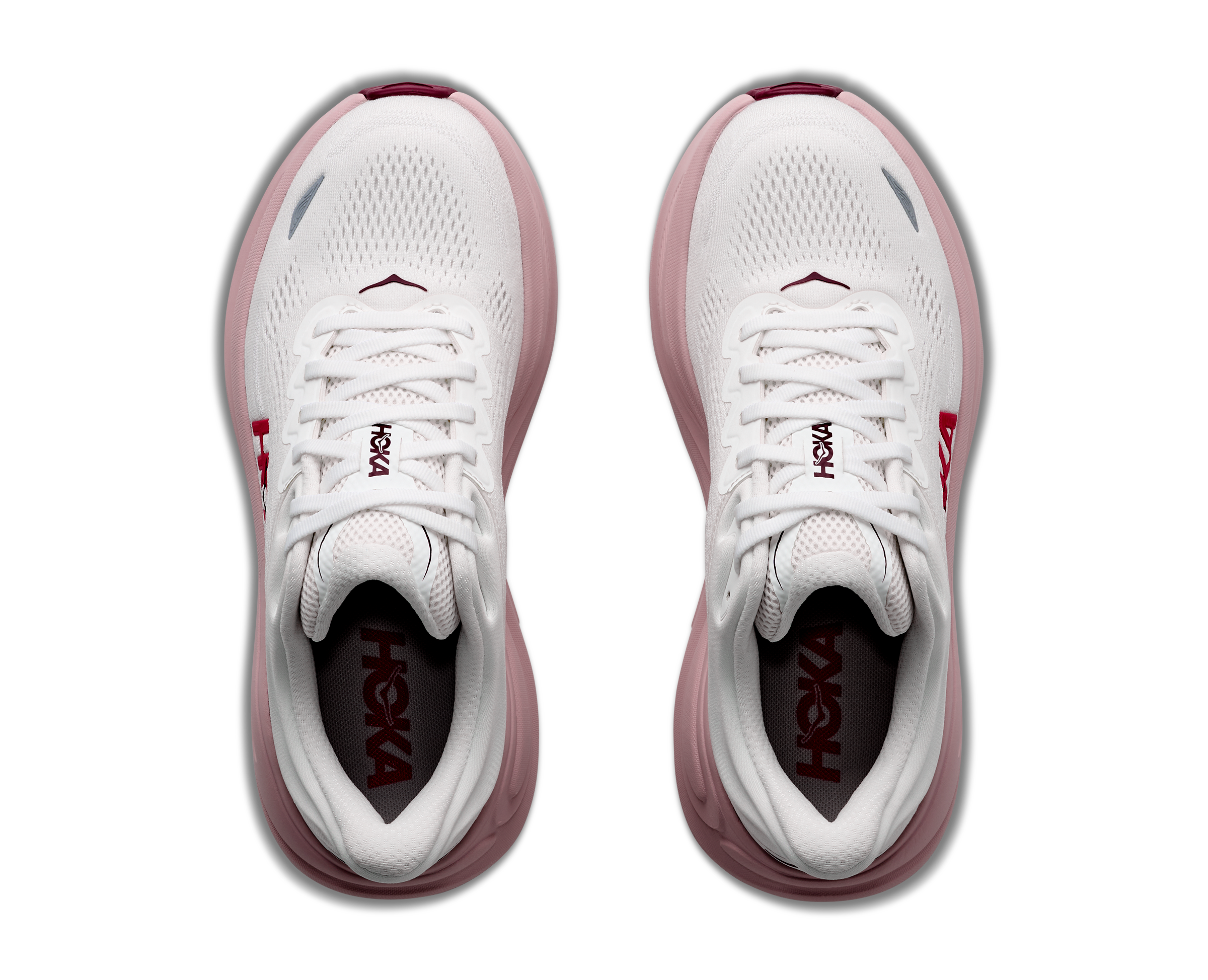White and pink running shoes with 'Hoka' branding on a white background