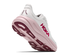 White running shoe with pink sole on a white background