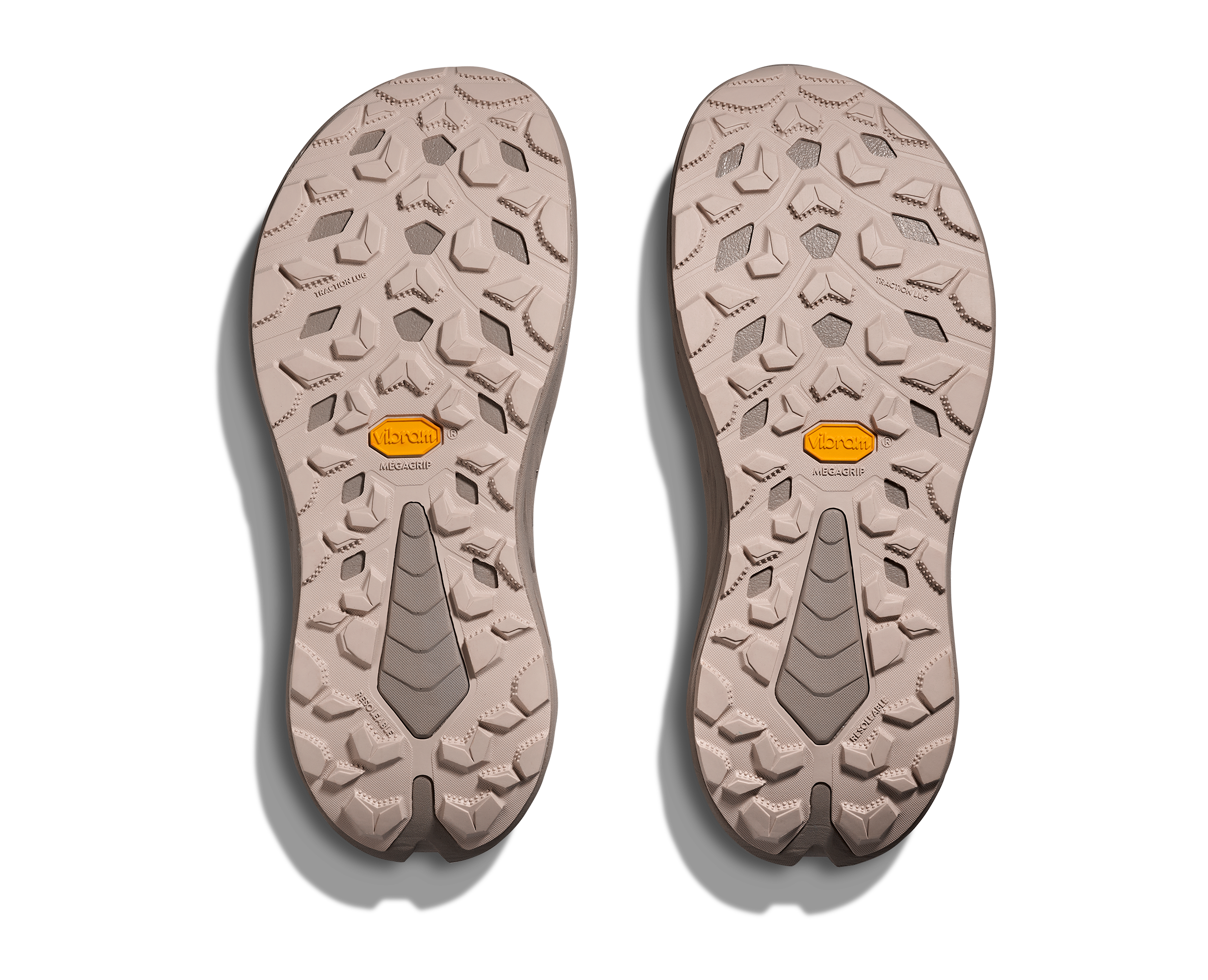 Two shoe soles with a textured pattern on a white background