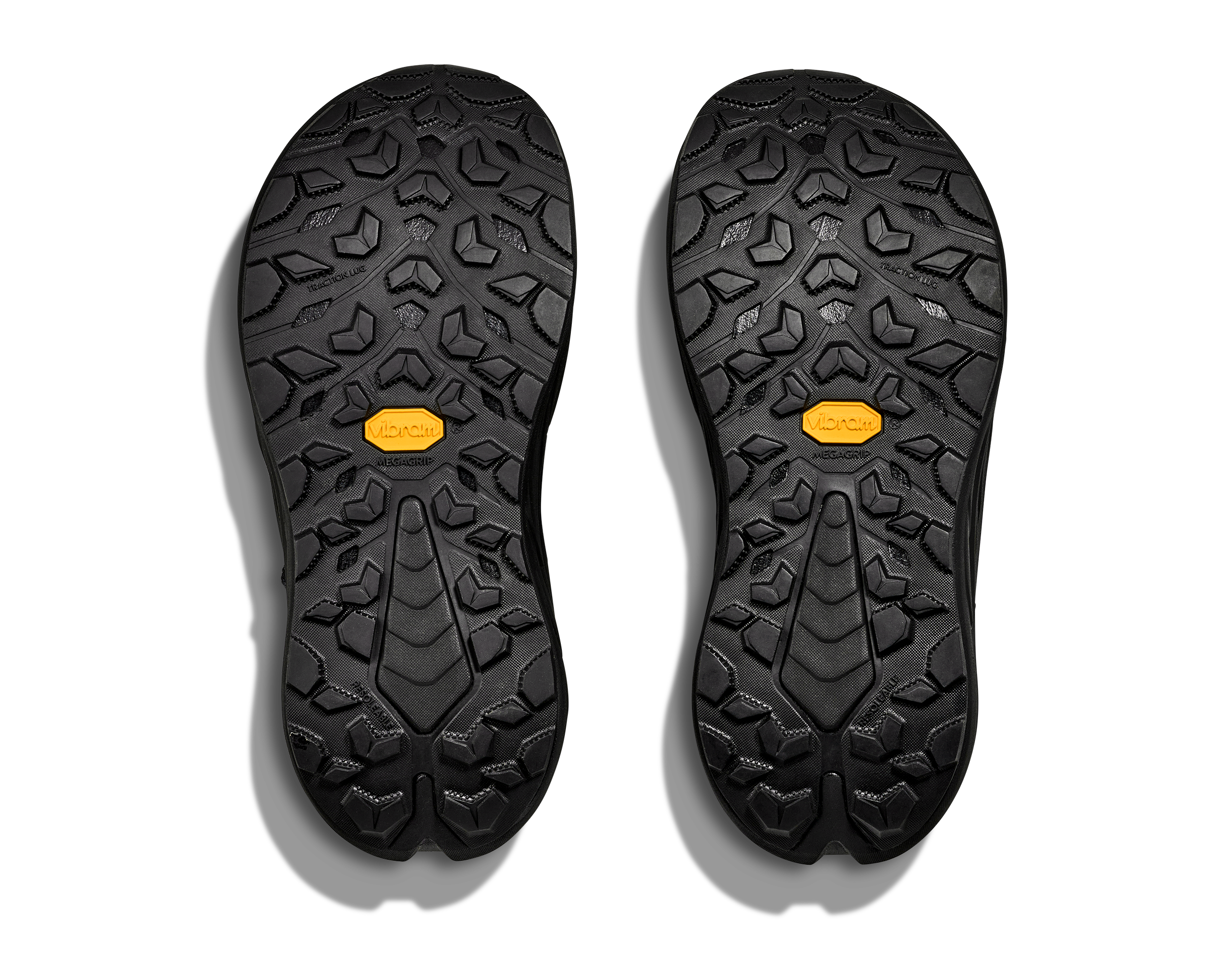 Black shoe soles with a yellow label on a white background
