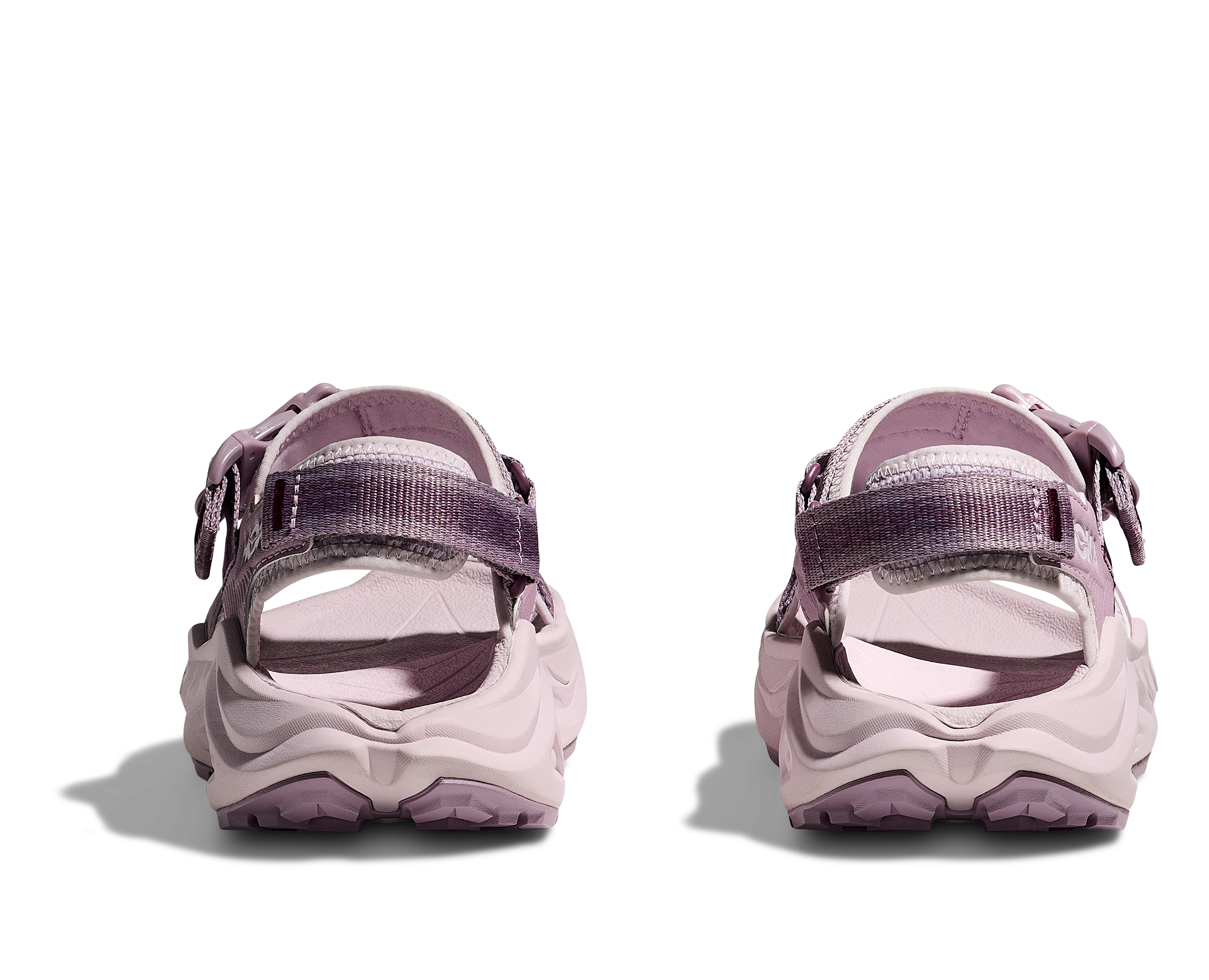 Pair of pink sandals with straps on a white background