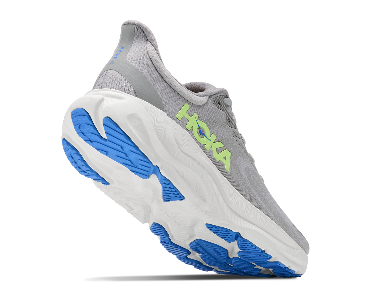 A Hoka running shoe in gray, white, and blue, shown from a three-quarters angle against a plain white background.