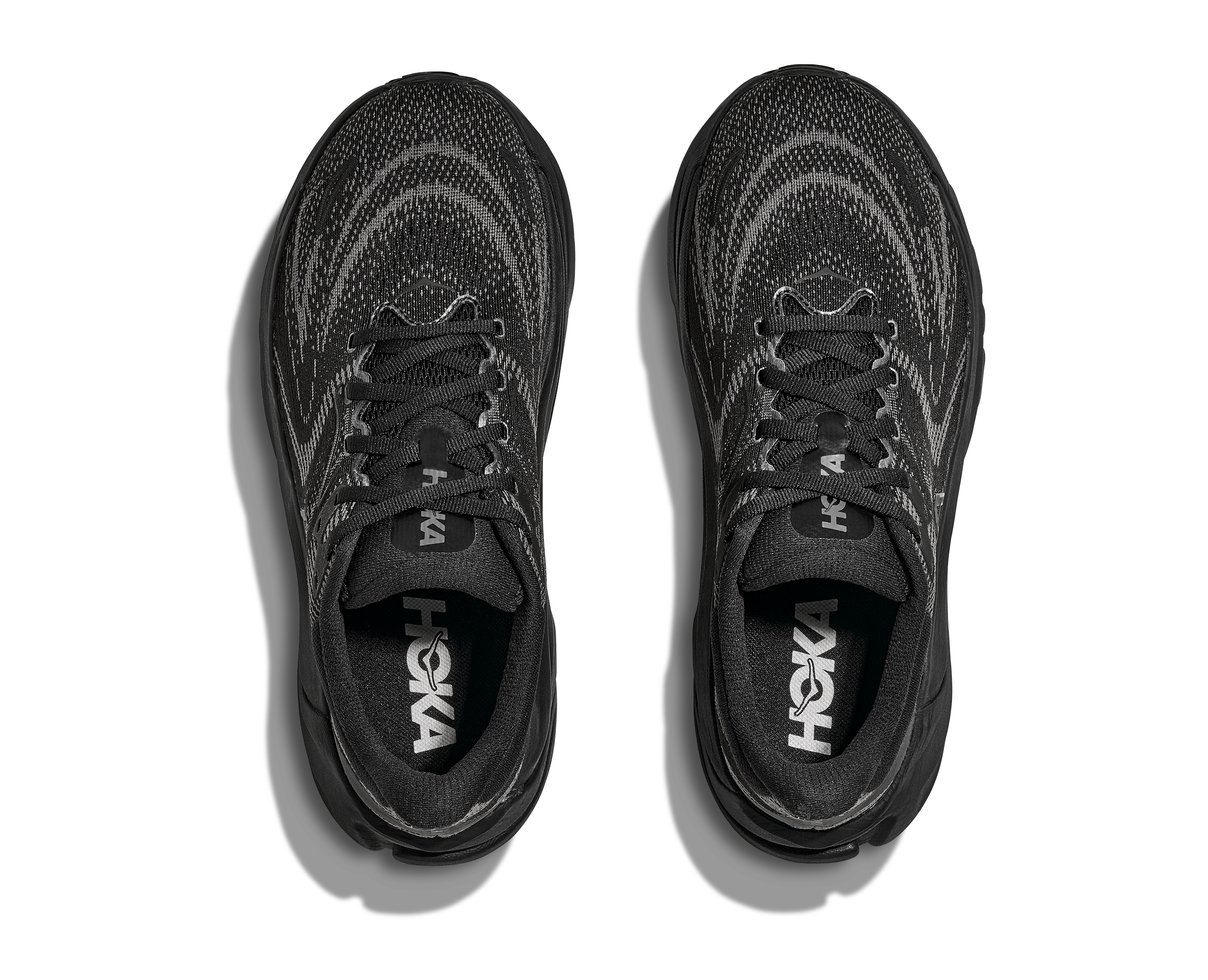 Black Hoka running shoes on a white background
