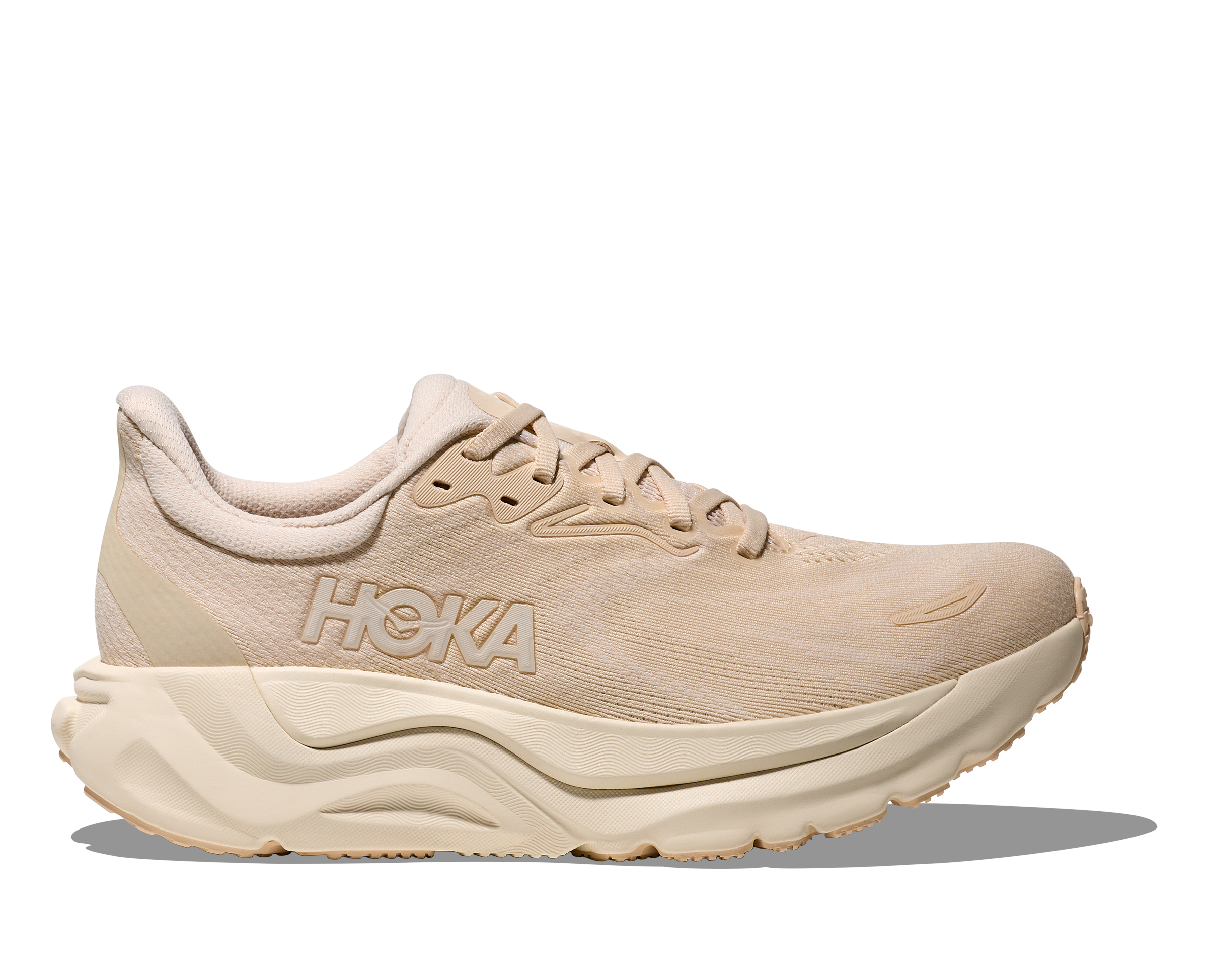 Beige running shoe with 'Hoka' branding on a white background