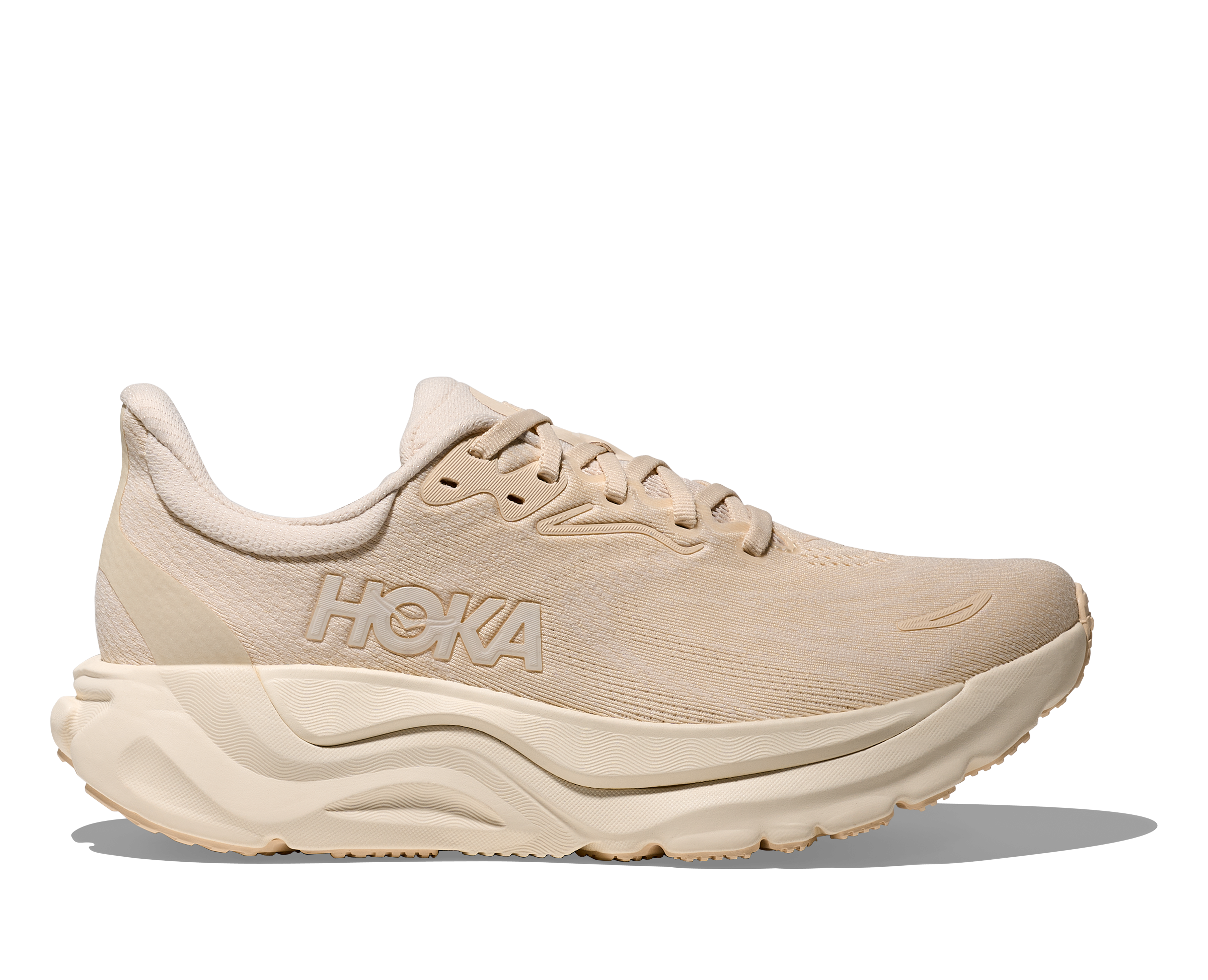 Beige running shoe with 'Hoka' branding on a white background