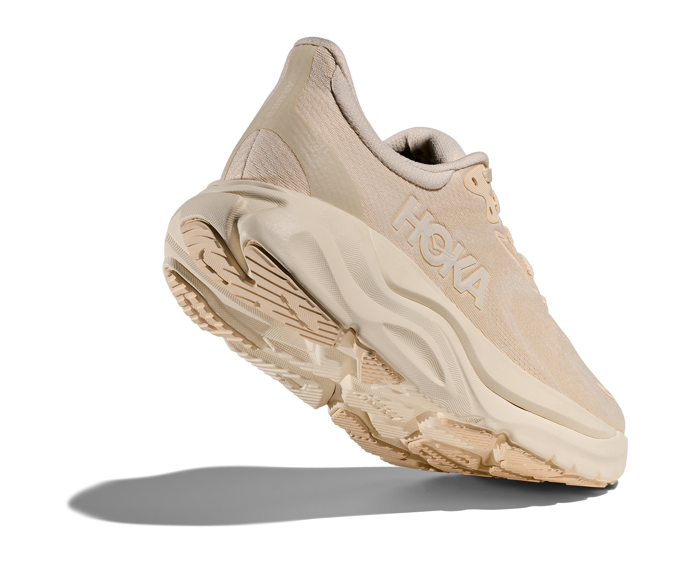 Beige running shoe with 'Hoka' branding on a white background