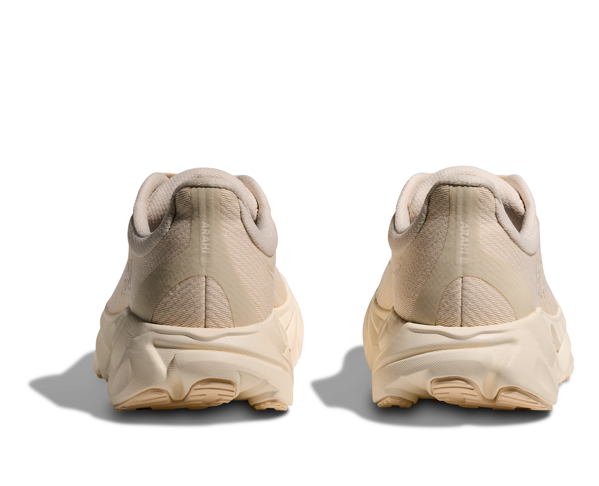 Beige sneakers shown from the back on a white background