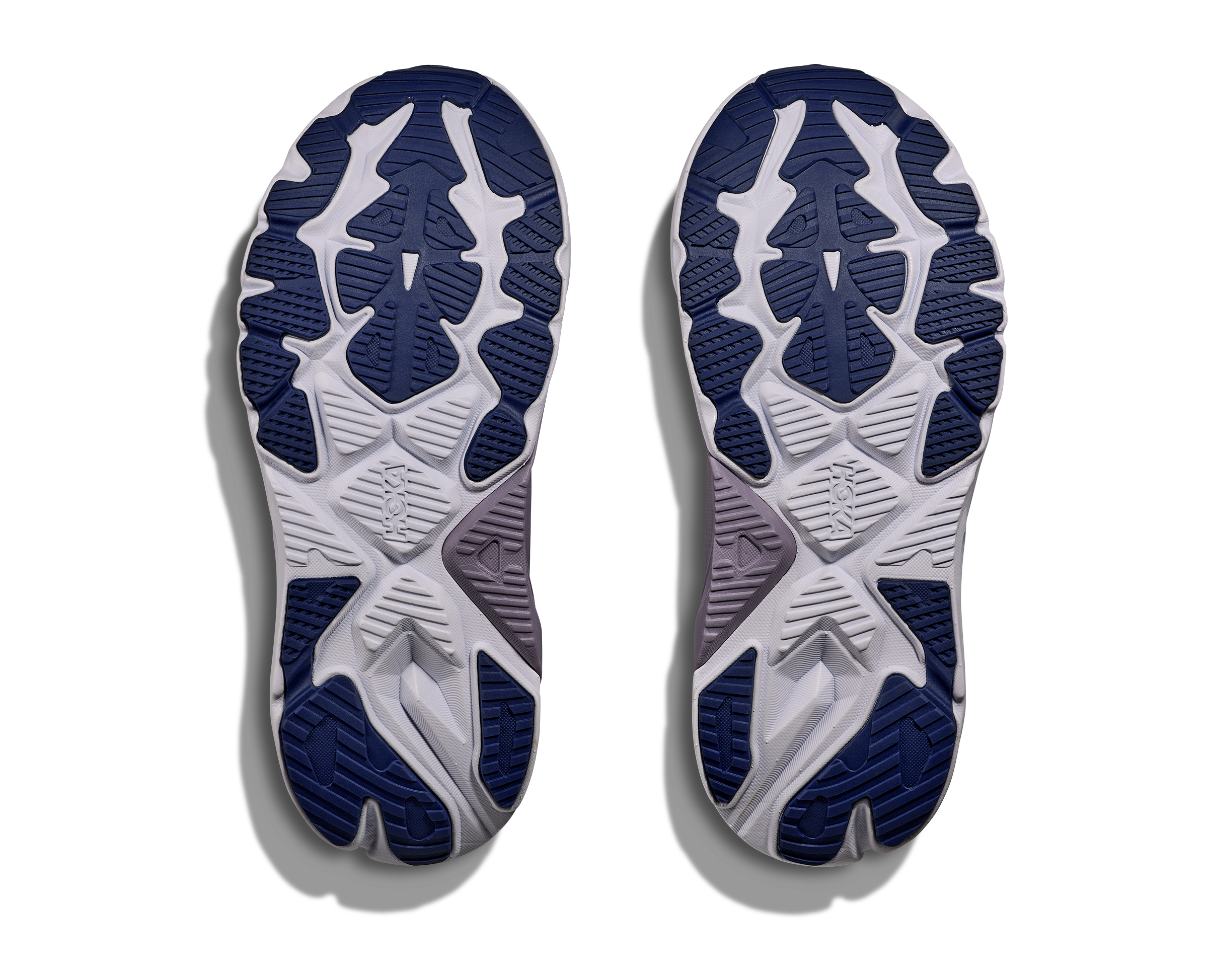 Close-up of a pair of running shoes with a focus on the sole design.