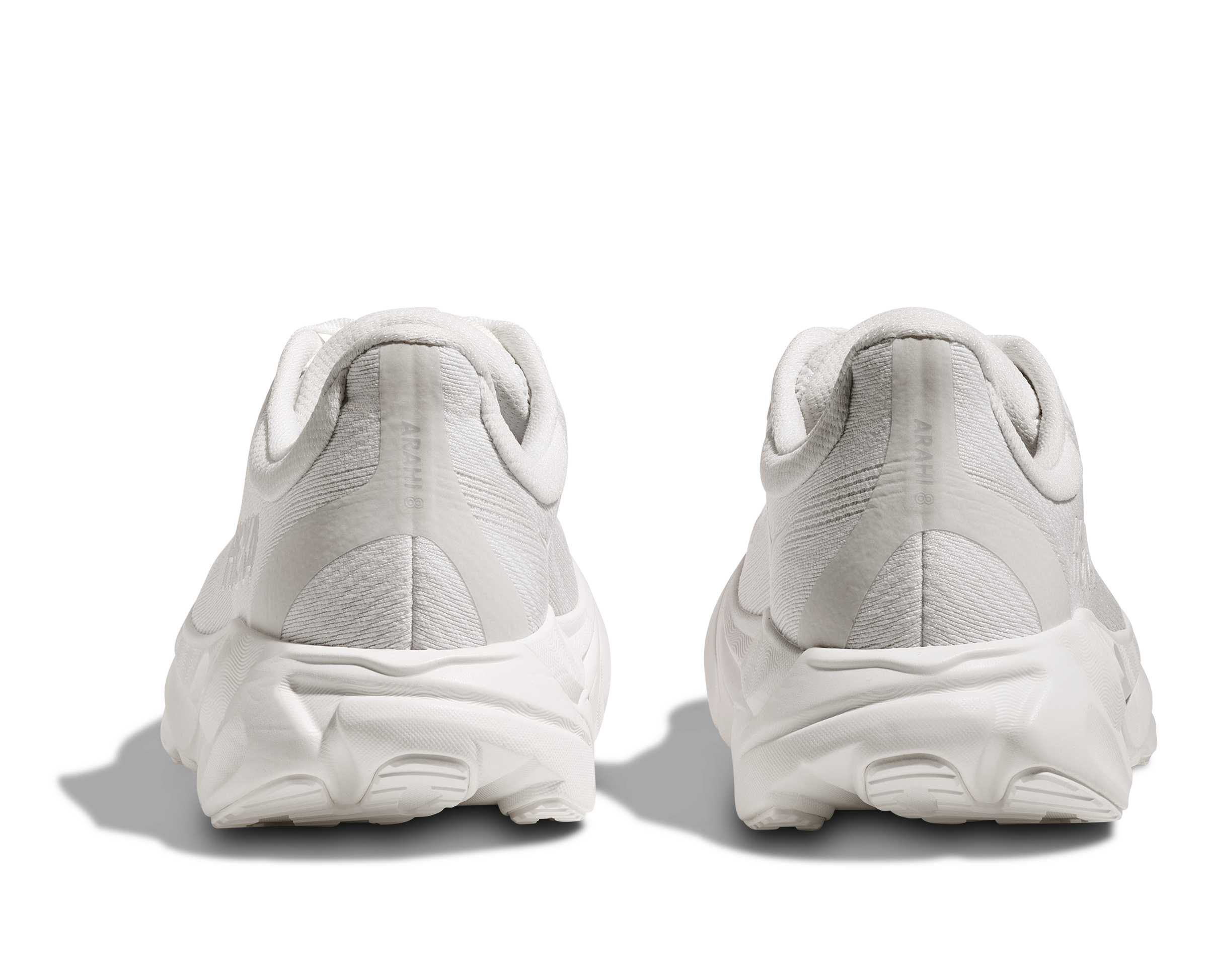 White athletic shoes shown from the back on a white background