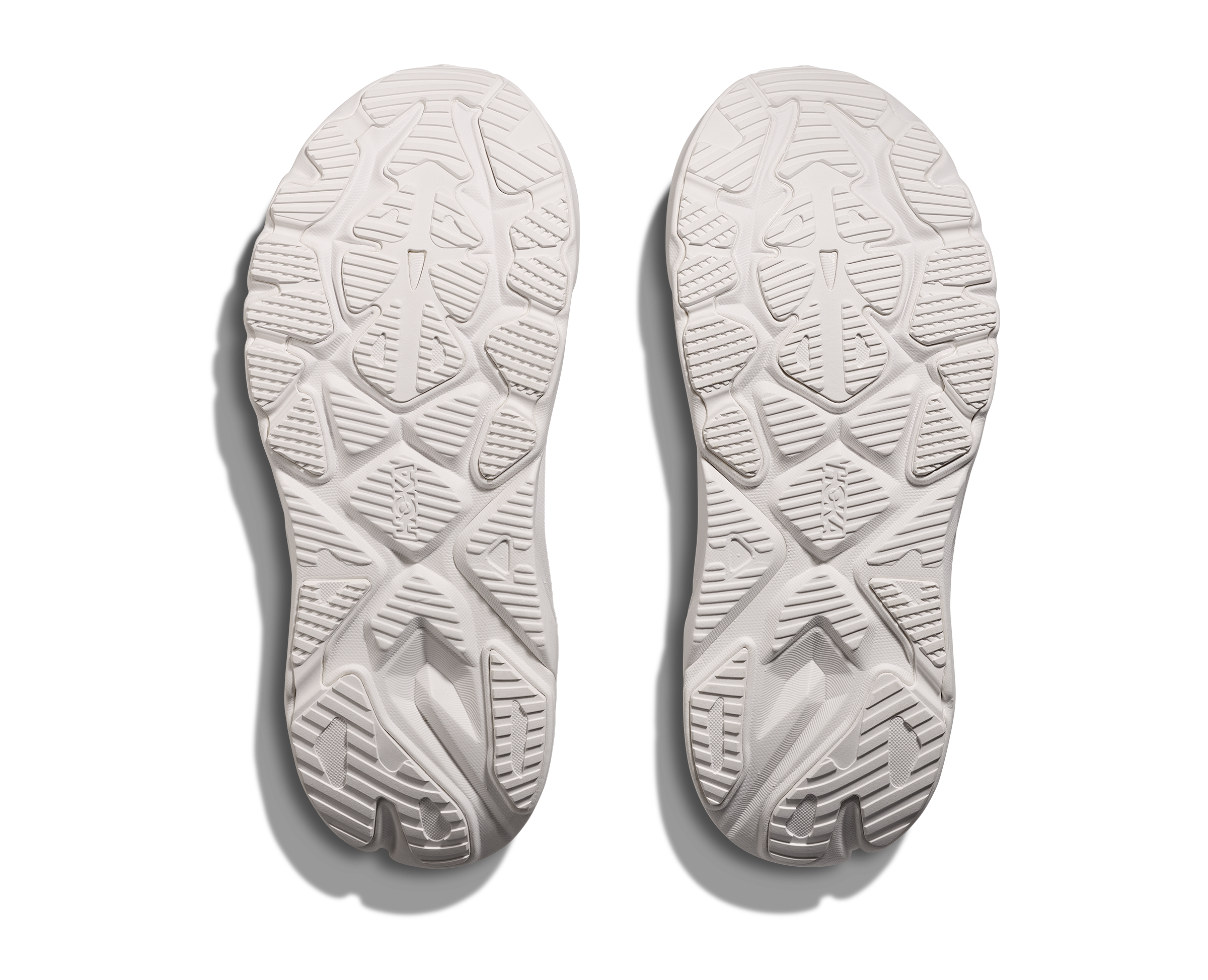 White shoe soles with tread pattern on a white background