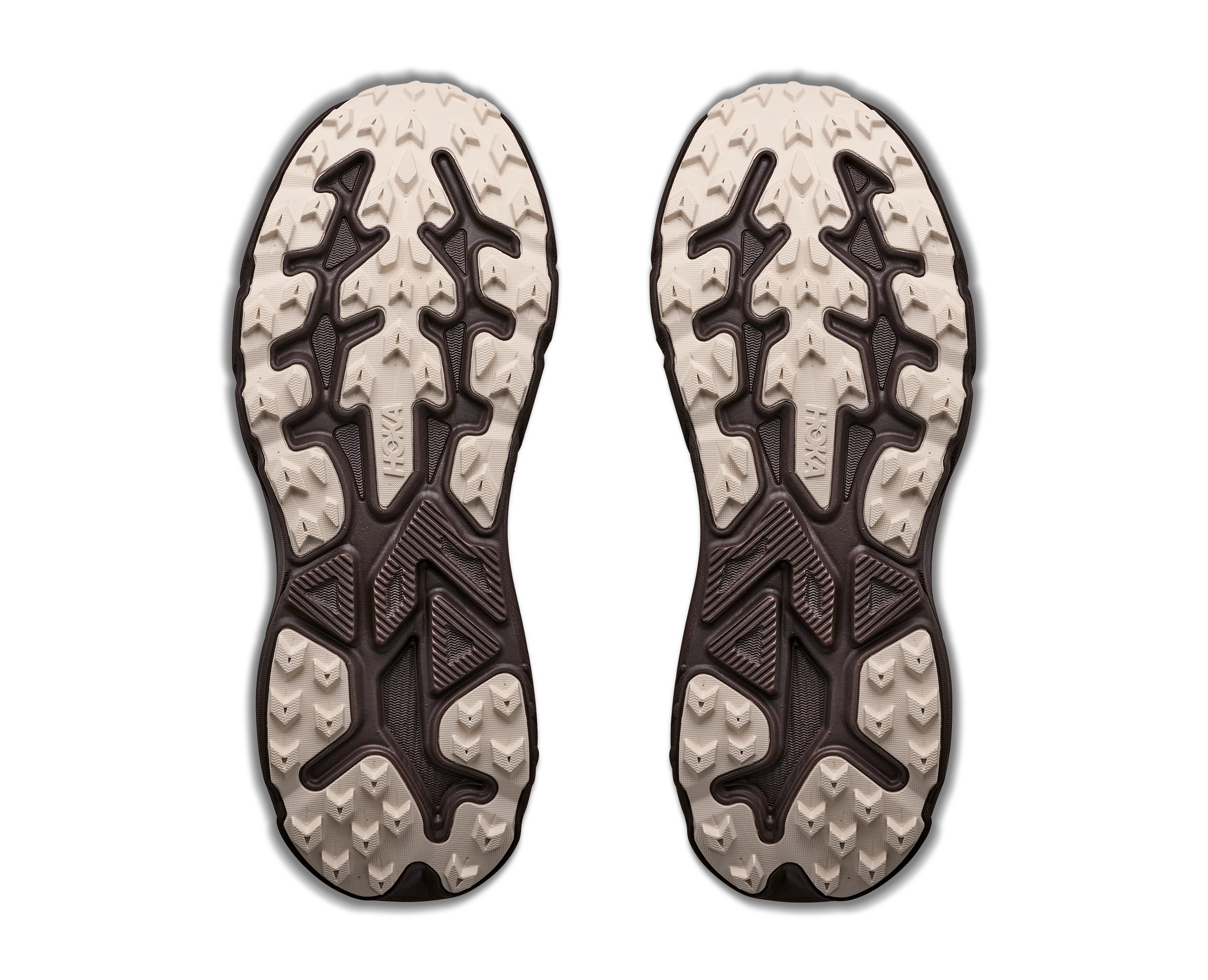 Pair of shoe soles with tread pattern on a white background