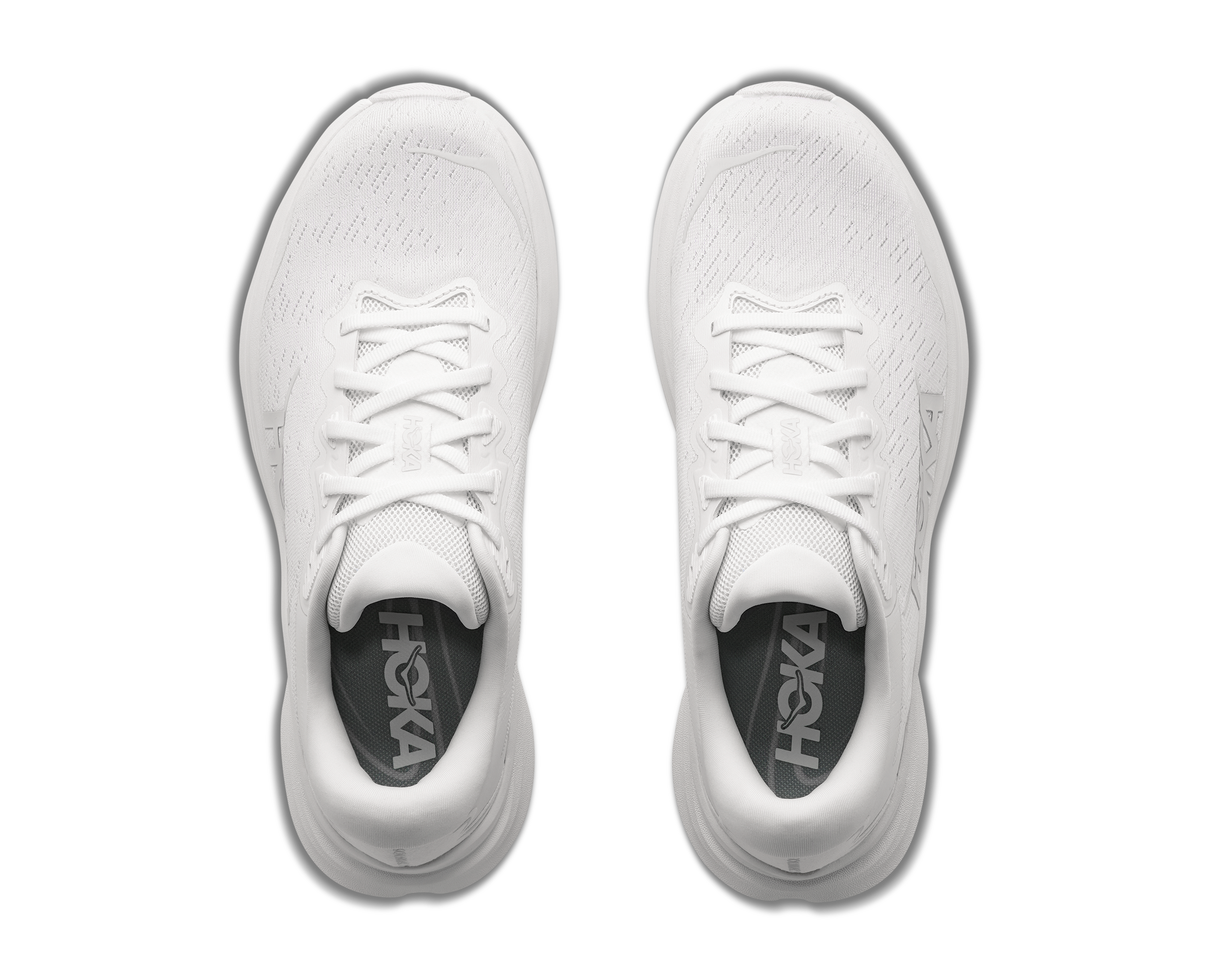 White running shoes with 'Hoka' branding on a white background