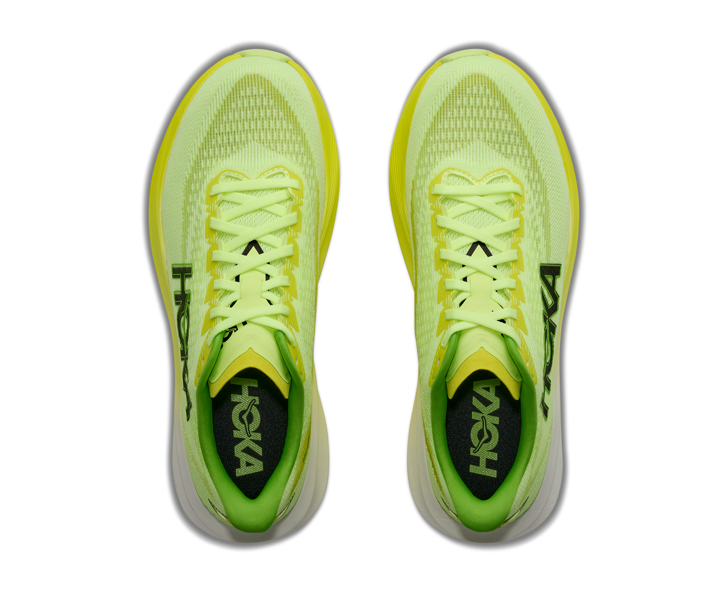 Pair of neon green running shoes with 'Hoka' branding on a white background